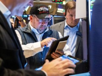 A trader wearing a Trump hat works on the floor of the New York Stock Exchange